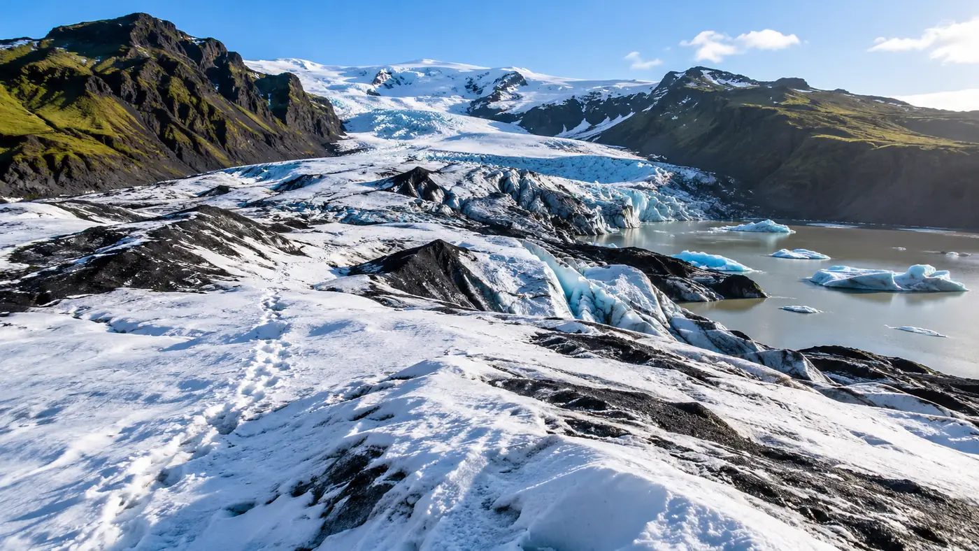 Snow-dusted glacier ice with crampon tracks